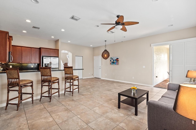 living room with light tile patterned floors, recessed lighting, visible vents, ceiling fan, and baseboards