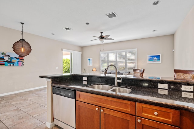 kitchen with brown cabinets, visible vents, a sink, and stainless steel dishwasher