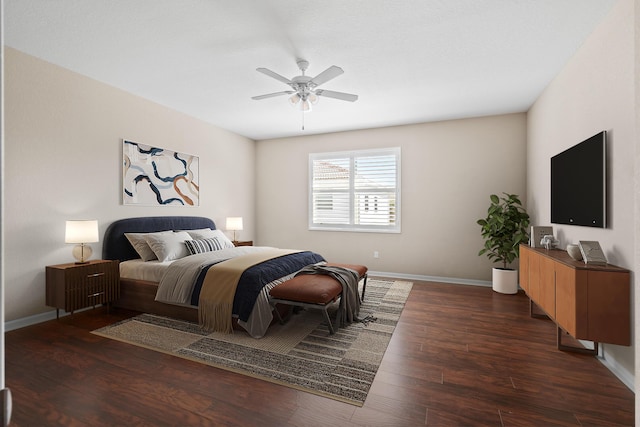 bedroom with a ceiling fan, baseboards, and dark wood-style flooring