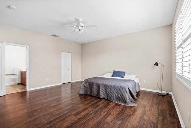 bedroom featuring multiple windows, visible vents, baseboards, and wood finished floors