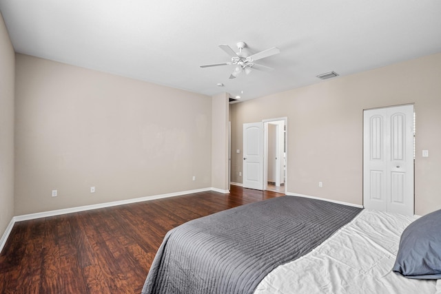 bedroom featuring visible vents, baseboards, and wood finished floors