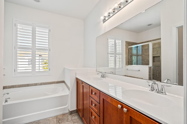 bathroom featuring double vanity, a sink, a shower stall, and a bath