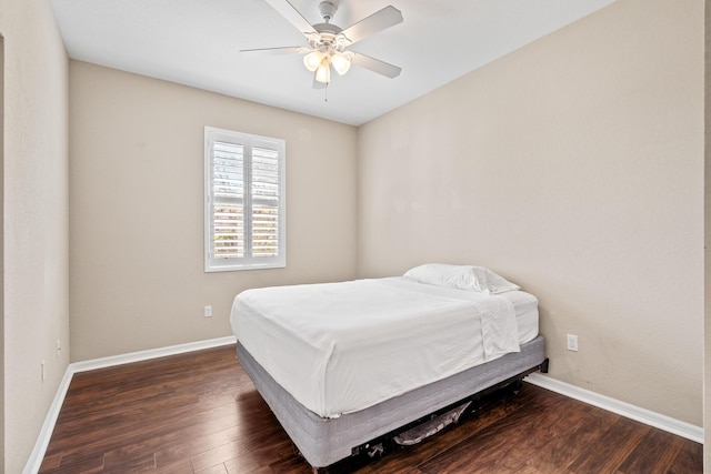 bedroom with ceiling fan, baseboards, and wood finished floors