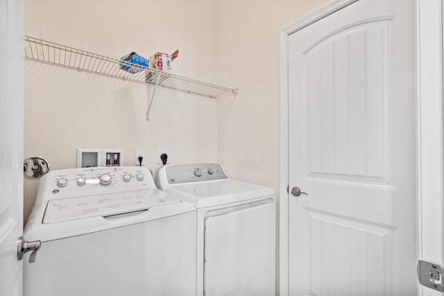 laundry room with laundry area and washing machine and clothes dryer