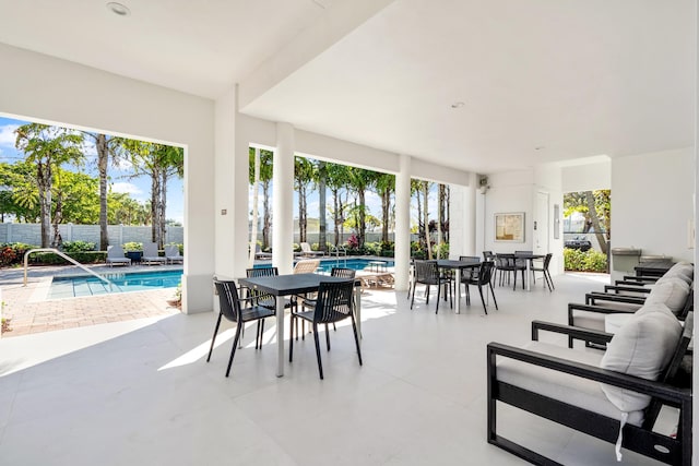 view of patio / terrace with a fenced in pool, outdoor dining space, and fence