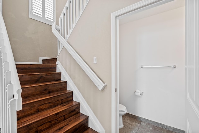 stairway featuring tile patterned flooring and baseboards