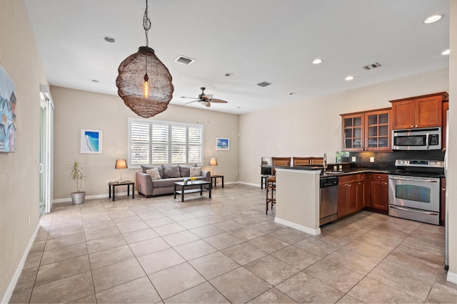 kitchen with visible vents, appliances with stainless steel finishes, open floor plan, and a sink