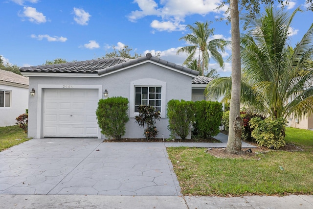 view of front of property featuring a front yard and a garage