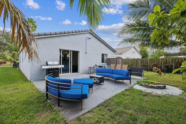 rear view of house with outdoor lounge area, a patio area, and a yard