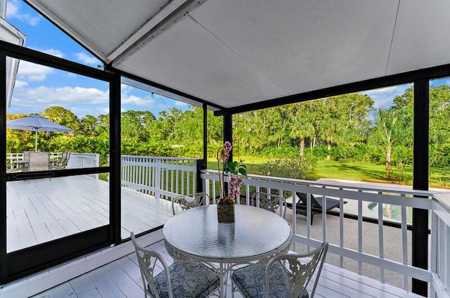 sunroom / solarium with vaulted ceiling and a wealth of natural light