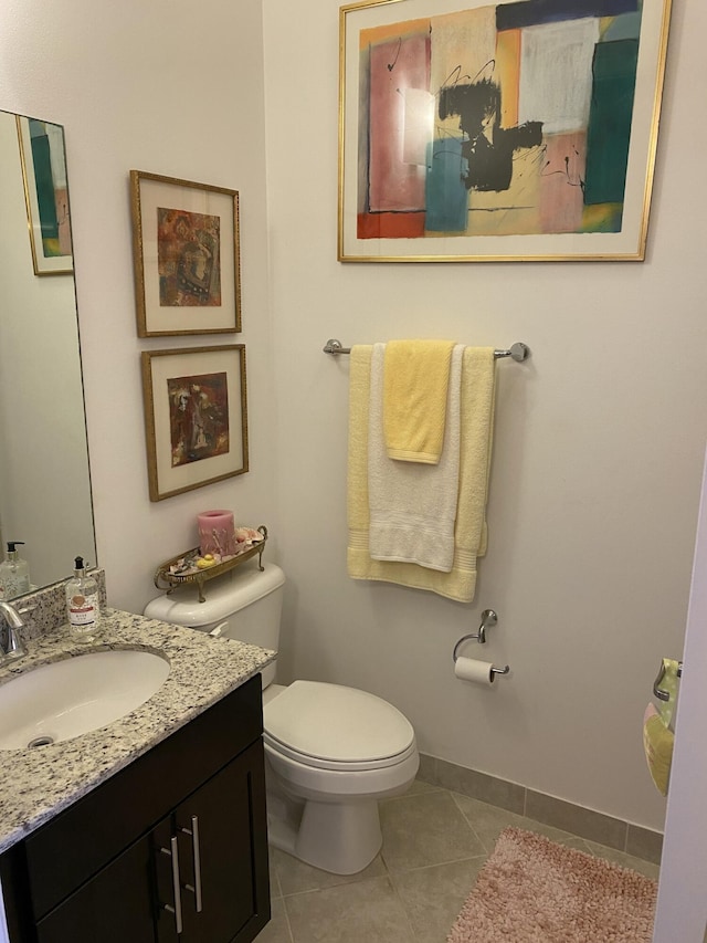 bathroom featuring toilet, tile patterned floors, and vanity