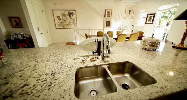 room details featuring sink and light stone counters