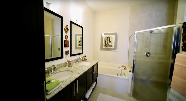 bathroom featuring vanity and independent shower and bath