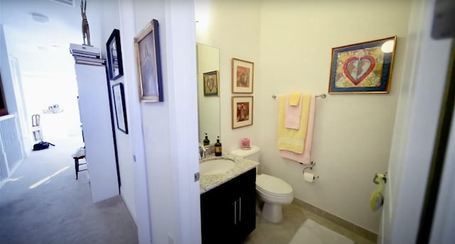 bathroom featuring toilet, vanity, and tile patterned floors