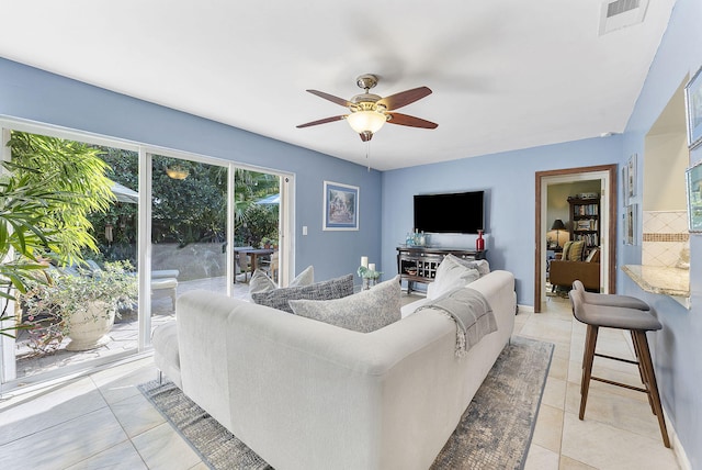 tiled living room featuring ceiling fan