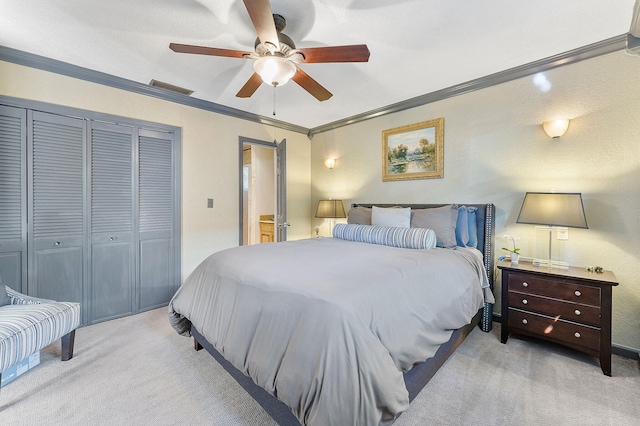 bedroom with light carpet, a ceiling fan, visible vents, a closet, and crown molding