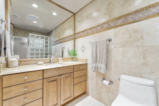 bathroom with vanity, tile walls, and walk in shower