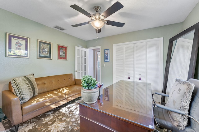 office space with visible vents and ceiling fan