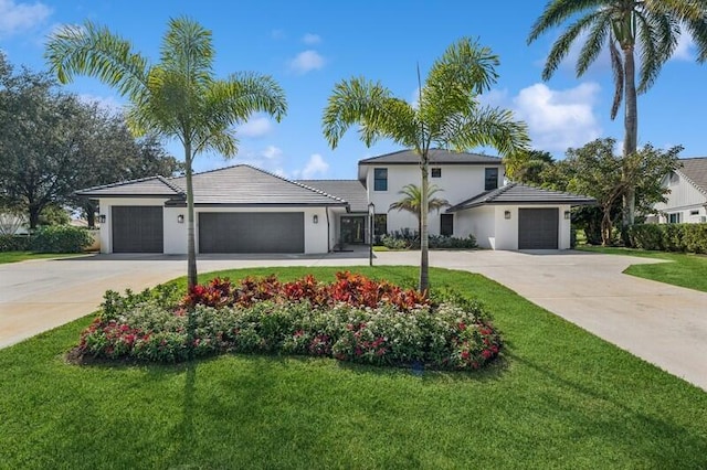 view of front of property with a front lawn and a garage