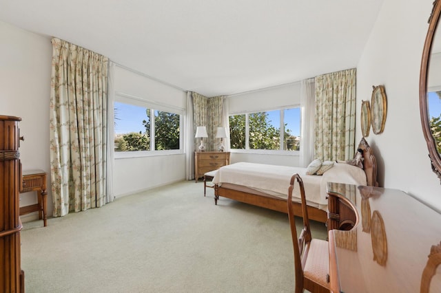 bedroom with light carpet and multiple windows