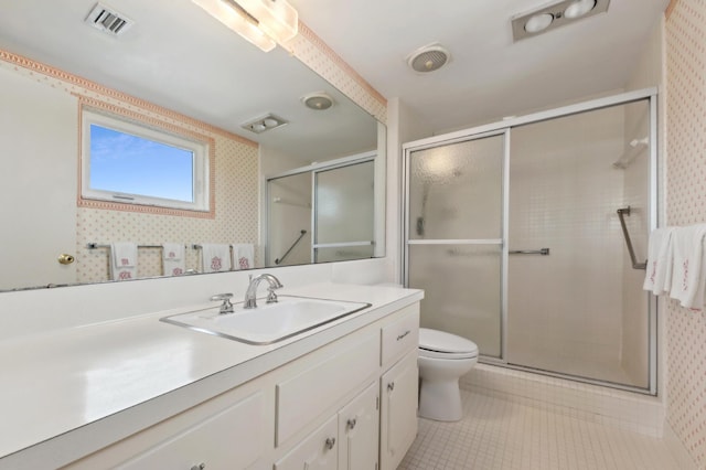 bathroom with vanity, a shower with shower door, and toilet