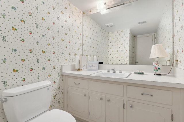 bathroom with vanity and toilet