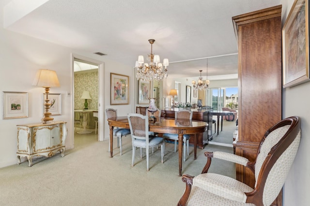 carpeted dining area featuring a notable chandelier