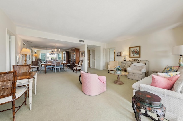 living room featuring carpet flooring and a notable chandelier