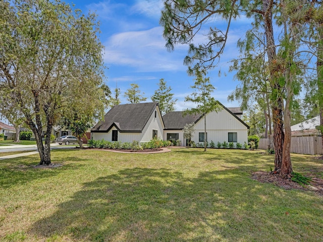 modern farmhouse style home featuring a front yard