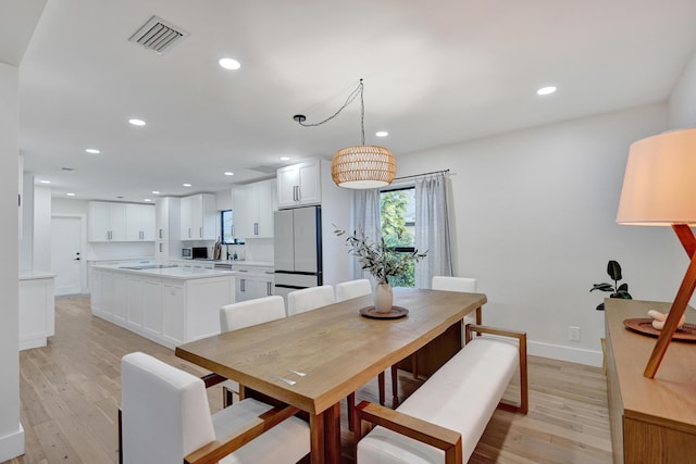 dining area with light hardwood / wood-style flooring