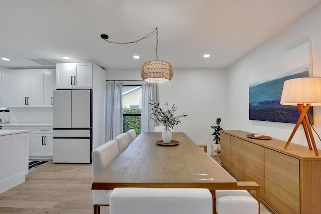 dining space with light wood-type flooring