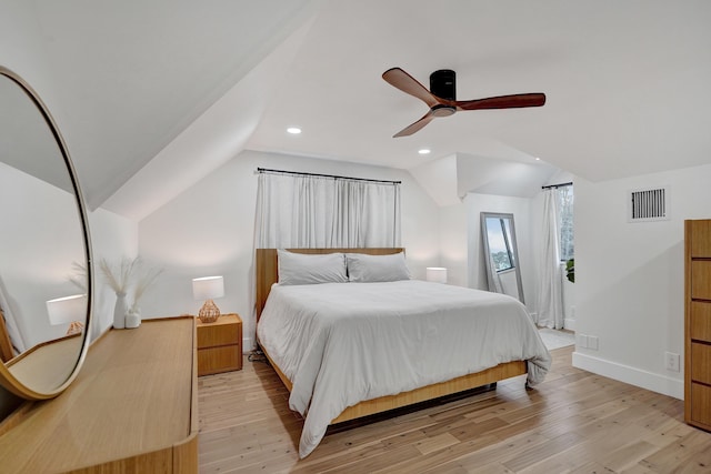 bedroom with ceiling fan, vaulted ceiling, and light hardwood / wood-style flooring