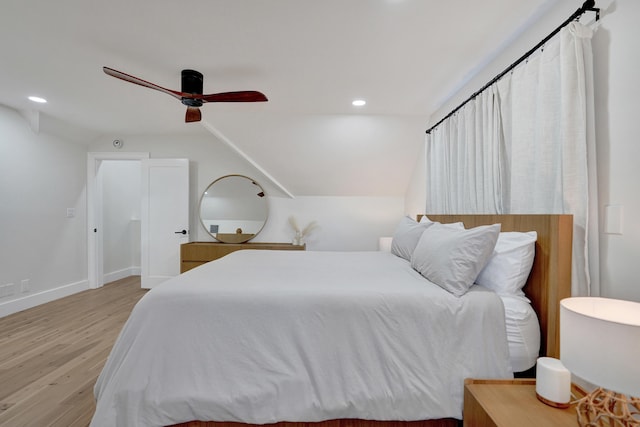 bedroom featuring lofted ceiling, light hardwood / wood-style floors, and ceiling fan