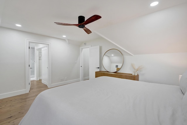 bedroom featuring vaulted ceiling, ceiling fan, and light hardwood / wood-style floors