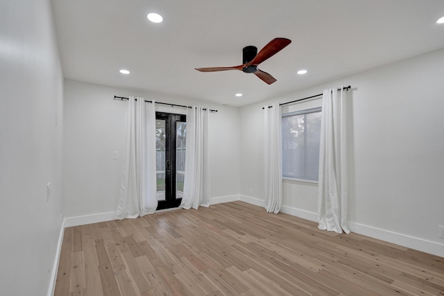 spare room with light hardwood / wood-style flooring and ceiling fan