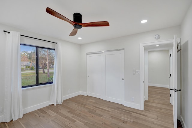 unfurnished bedroom with a closet, ceiling fan, and light hardwood / wood-style flooring