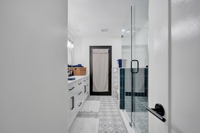 bathroom with vanity and an enclosed shower