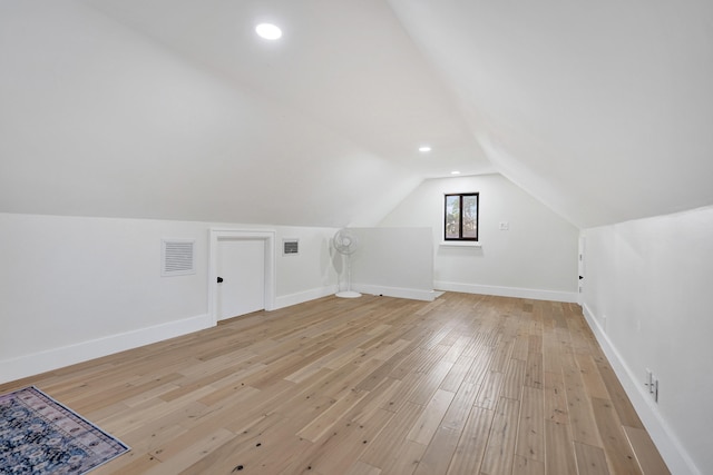 bonus room featuring lofted ceiling and light wood-type flooring