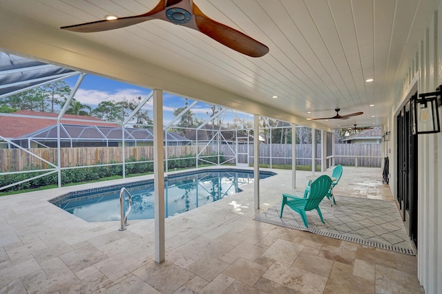 view of swimming pool with a patio, a lanai, and ceiling fan