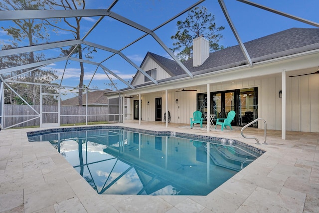 view of swimming pool with a patio, ceiling fan, and glass enclosure