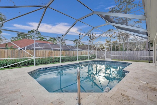 view of swimming pool with a patio area and glass enclosure