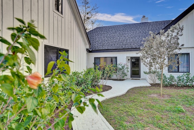 doorway to property with a lawn