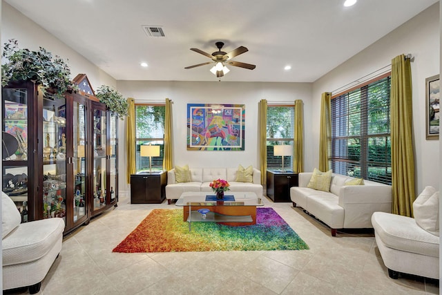 tiled living room with ceiling fan and a healthy amount of sunlight