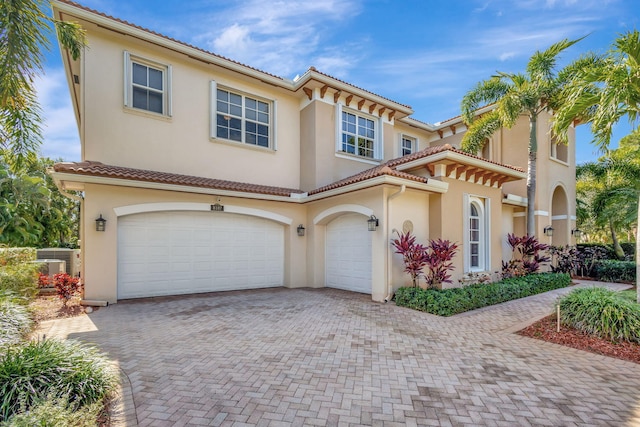 mediterranean / spanish house featuring a garage