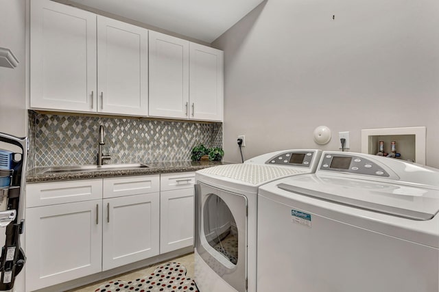 clothes washing area featuring cabinets, washer and clothes dryer, sink, and light tile patterned floors