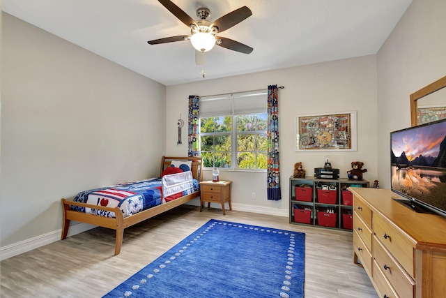 bedroom with ceiling fan and light wood-type flooring