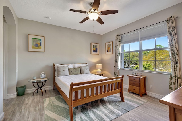 bedroom featuring light hardwood / wood-style floors and ceiling fan