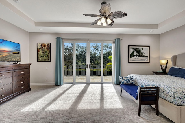 bedroom featuring french doors, ceiling fan, a tray ceiling, and access to exterior