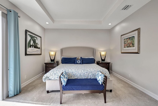 carpeted bedroom featuring a tray ceiling