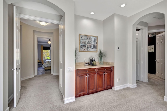 hallway with light colored carpet